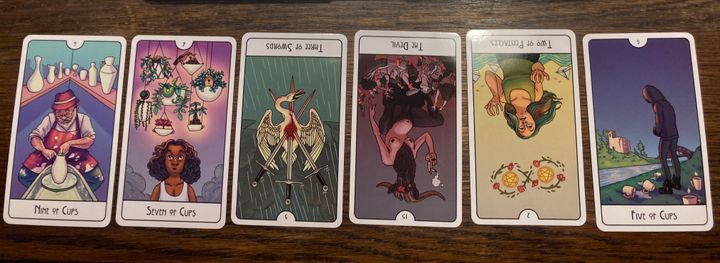 6-card pull featuring 9 of Cups, 7 of Cups, 3 of Swords (R), The Devil (R), 2 of Pentacles (R), and 5 of Cups